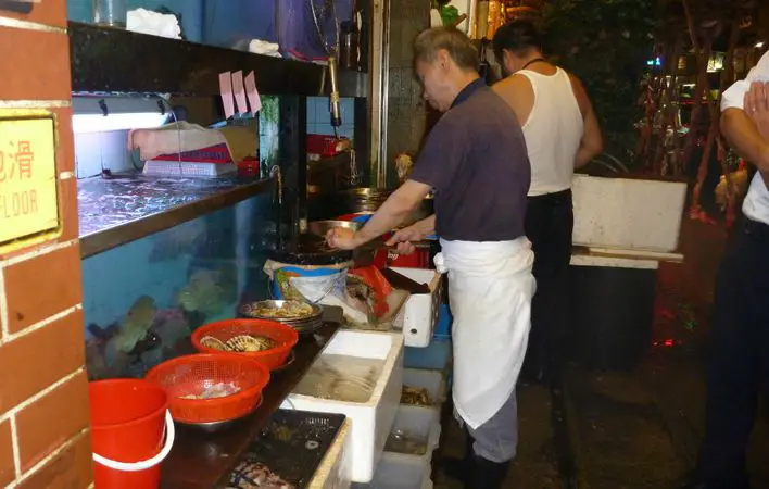 Seafood tanks and cooks at street food stalls Seafood tanks and cooks at street food stalls