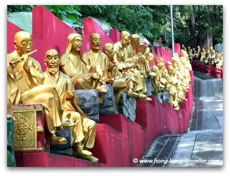 Path to the Ten Thousand Monastery flanked by Buddha Statues on both sides Path to the Ten Thousand Monastery flanked by Buddha Statues on both sides